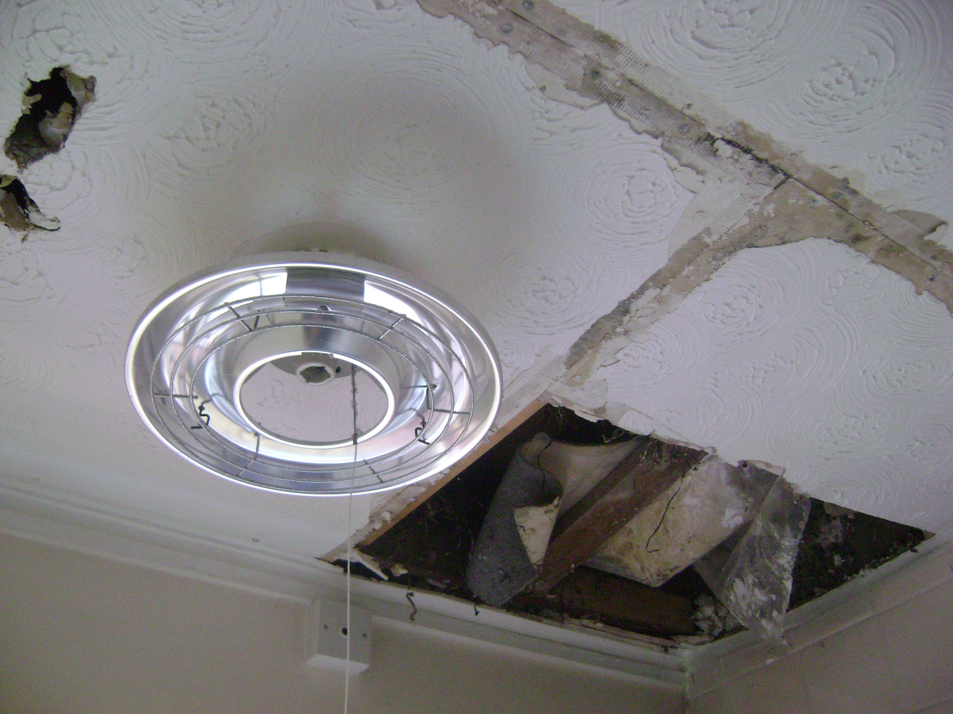 This bathroom ceiling was damaged by a leak in the roof.