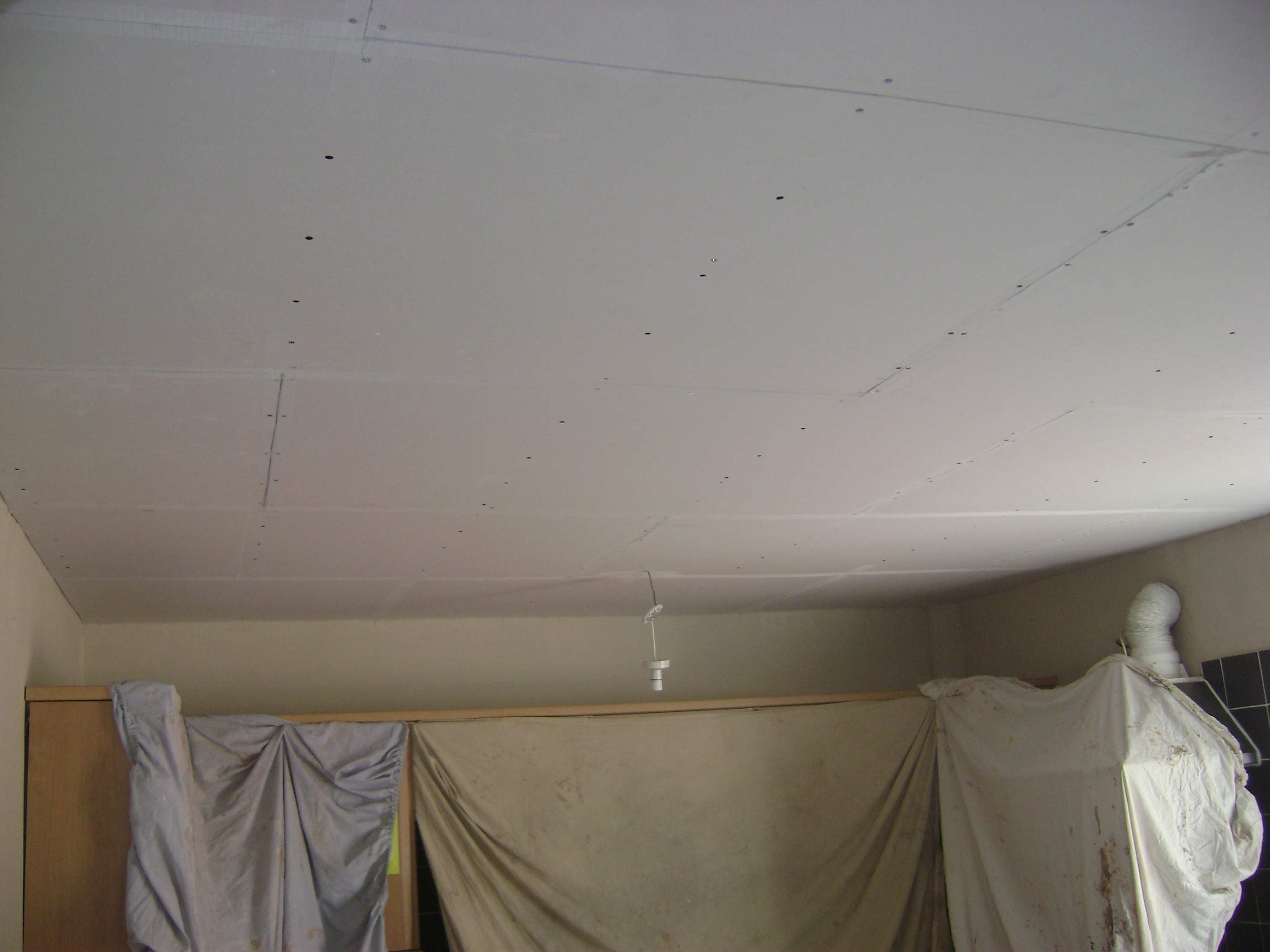 After scraping back the blown areas it became apparent the board was no good so the whole ceiling was overboarded